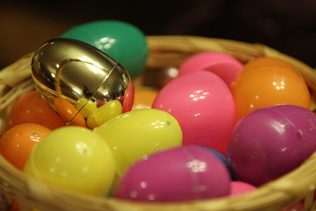 golden egg in a basket of pastel easter eggs