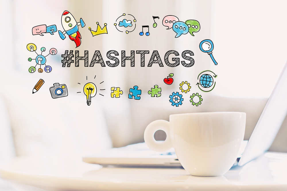 Hashtags concept with a cup of coffee and a laptop